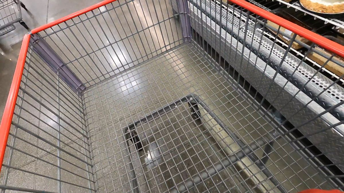 A shopping cart in a grocery aisle.